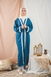 Hosn Kaftan Petrol is  linen fabric provides a sleek, polished look,allowing for effortless movement and timeless charm.