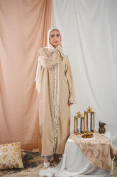 Zahra Kaftan beige crafted from Fresca fabric, features a unique design along the edges and sleeves, blending elegance with modern charm