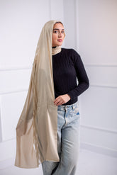 Silky Gold  long hijab with line design, worn with casual jeans and a black top – back view1