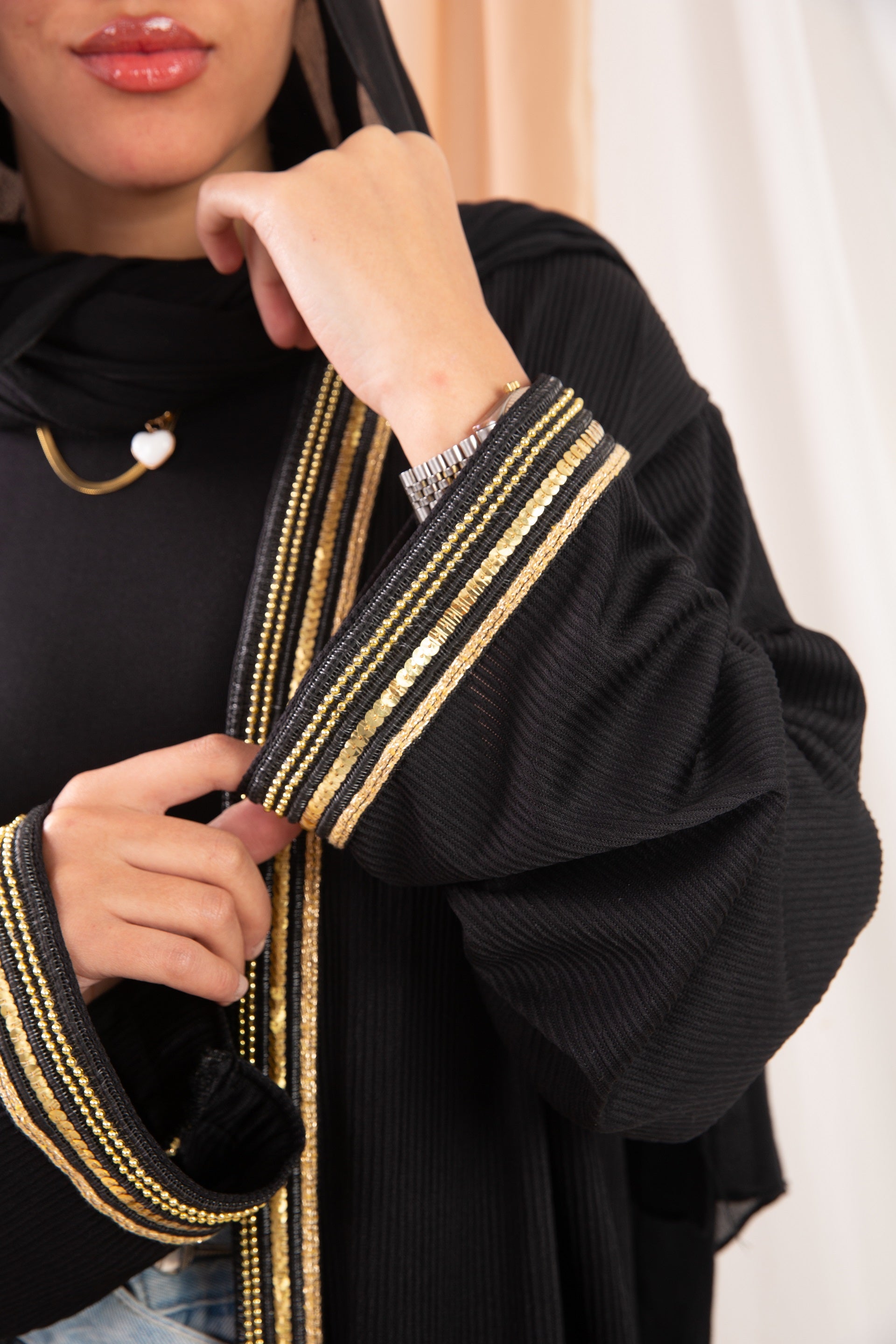 Nojom Kaftan  Black crafted from crinkle rib-knitted fabric, is adorned with delicate gold lines, adding a touch of elegance and sophistication.