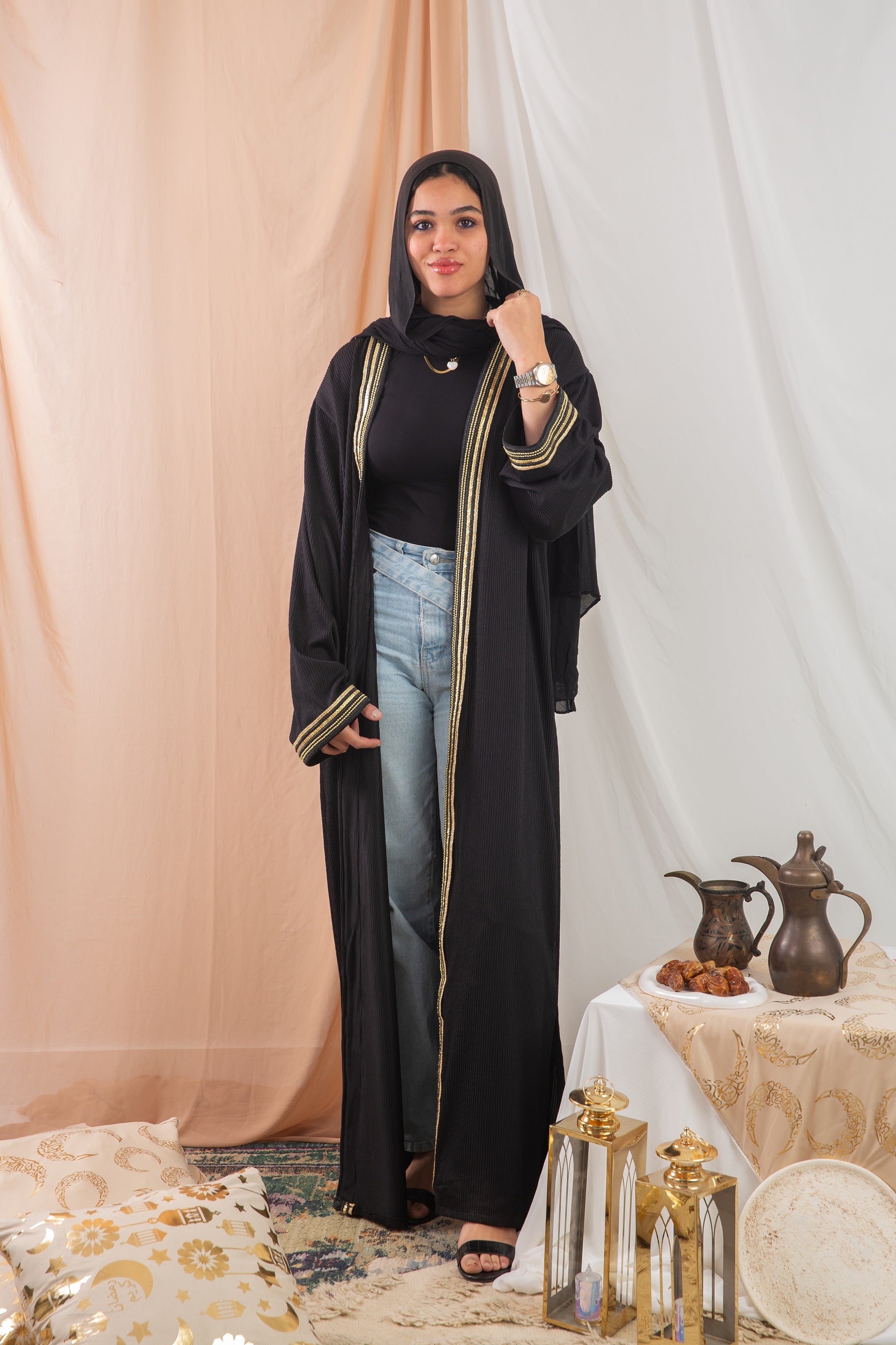 Nojom Kaftan  Black crafted from crinkle rib-knitted fabric, is adorned with delicate gold lines, adding a touch of elegance and sophistication.