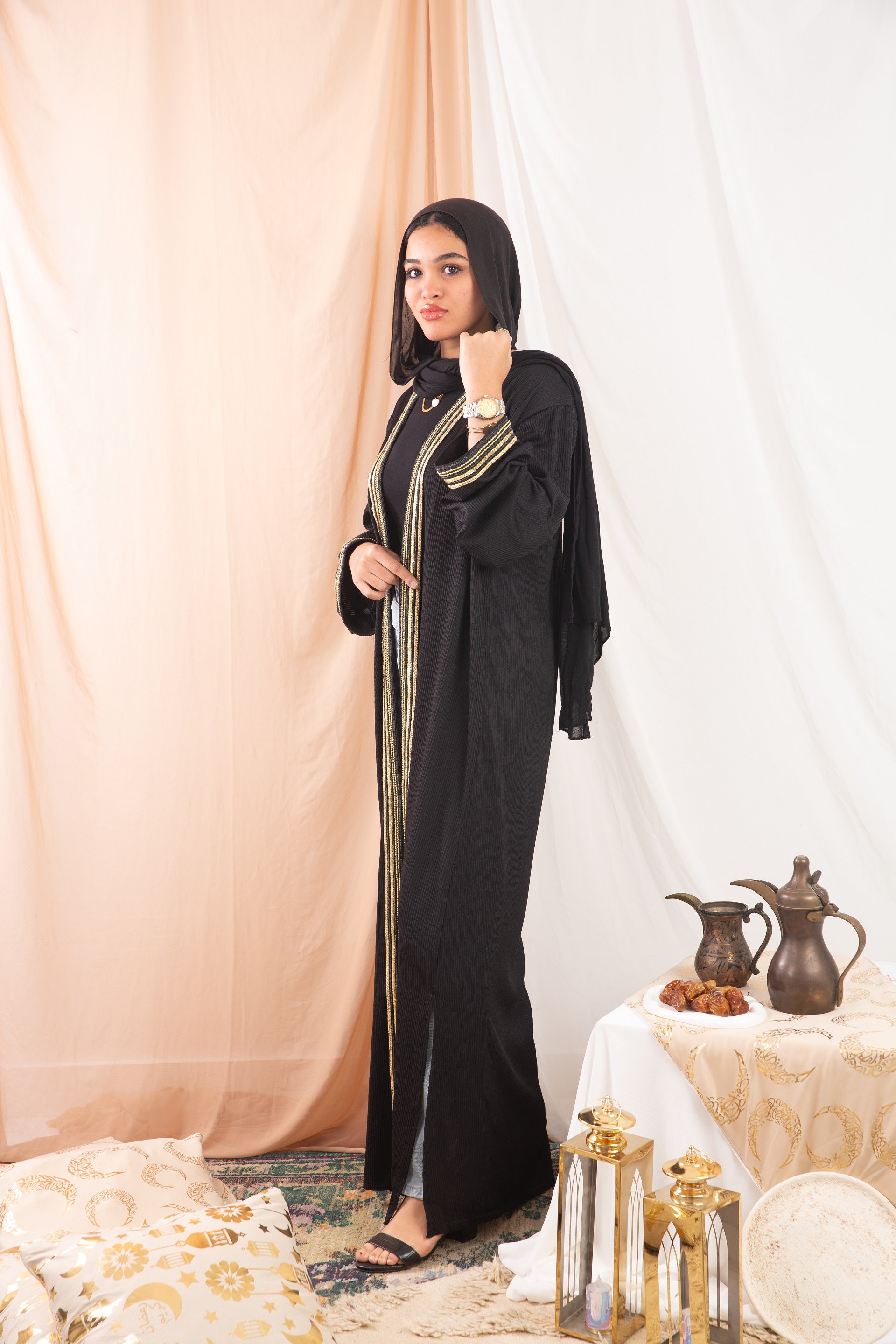 Nojom Kaftan  Black crafted from crinkle rib-knitted fabric, is adorned with delicate gold lines, adding a touch of elegance and sophistication.