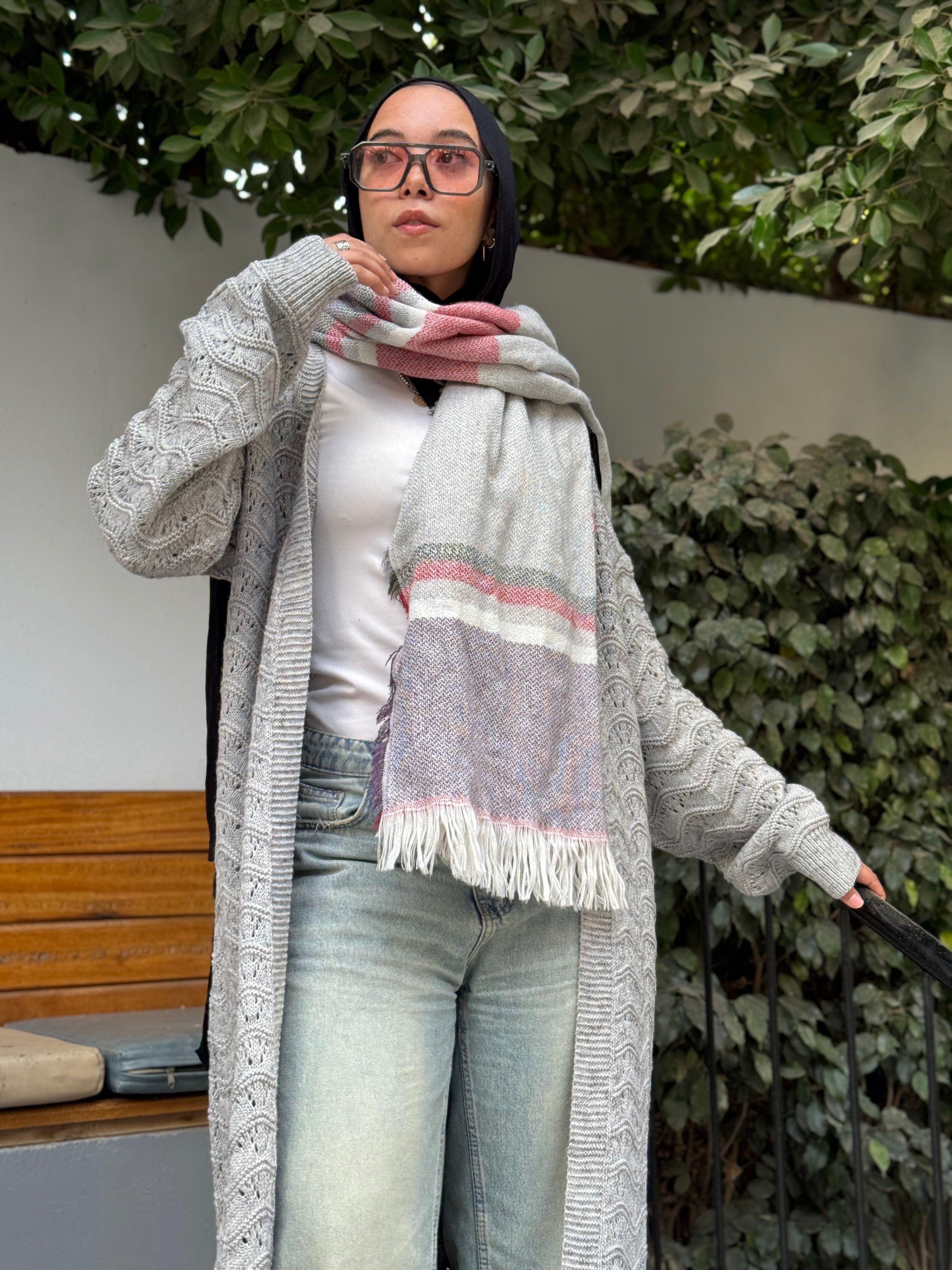 Stitchy Cardigan Gray crafted from trico fabric, featuring long sleeves for a cozy and stylish look.