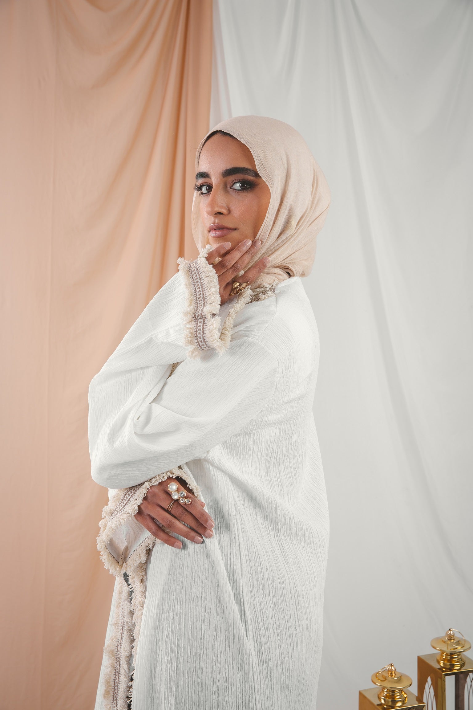 Zahra Kaftan white crafted from Fresca fabric, features a unique design along the edges and sleeves, blending elegance with modern charm