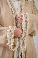 Zahra Kaftan beige_3 crafted from Fresca fabric, features a unique design along the edges and sleeves, blending elegance with modern charm