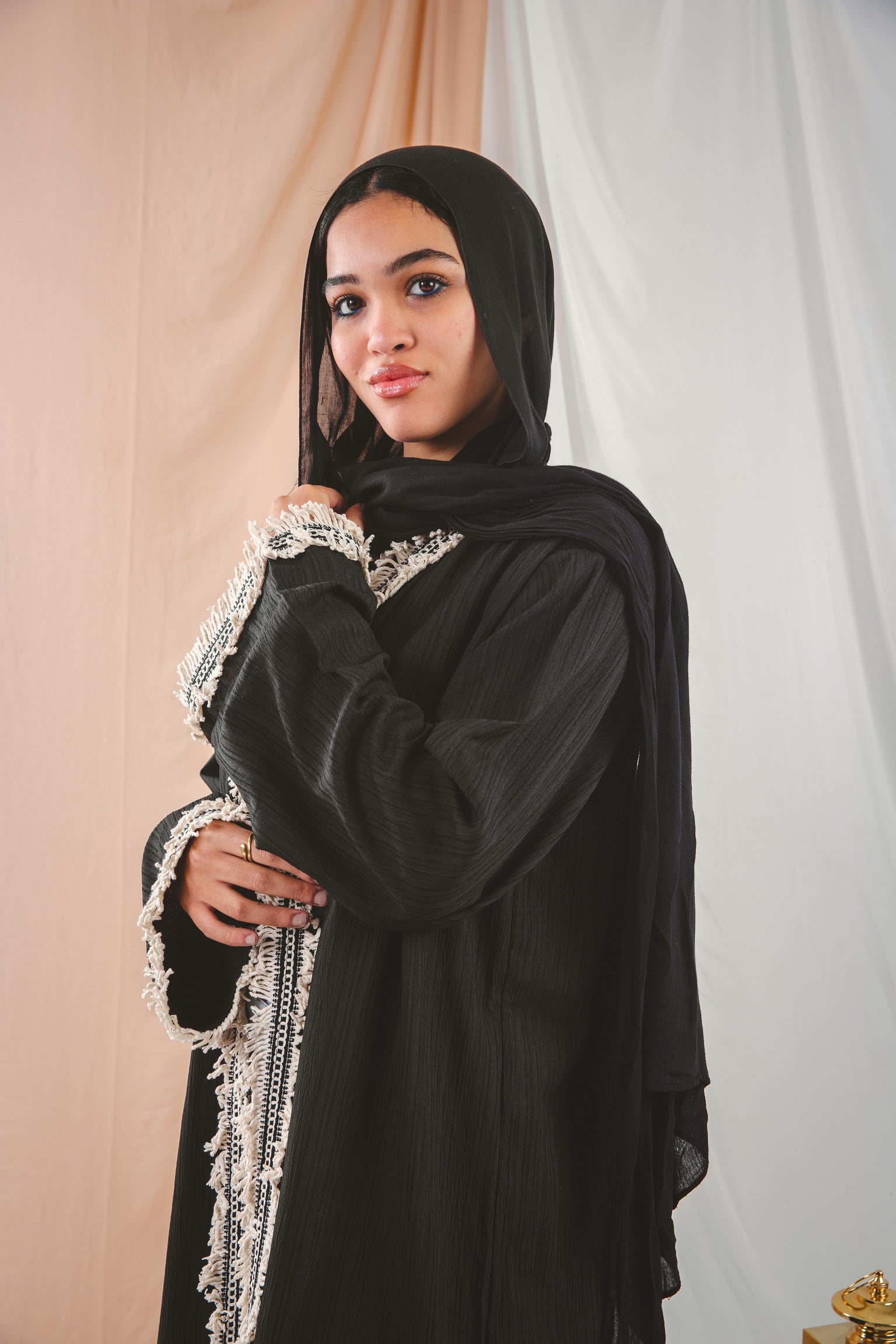 Zahra Kaftan black 3 crafted from Fresca fabric, features a unique design along the edges and sleeves, blending elegance with modern charm
