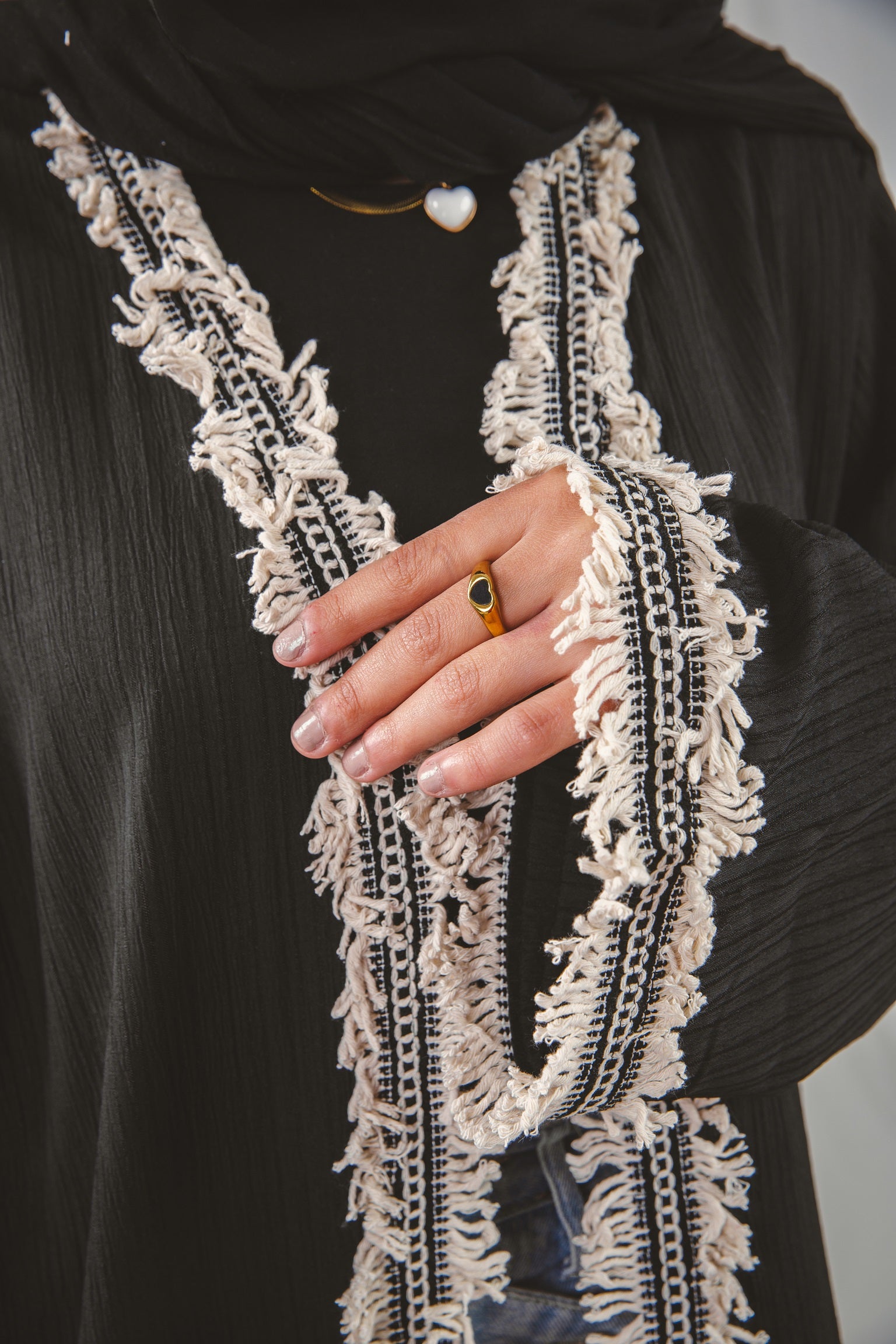 Zahra Kaftan black 4 crafted from Fresca fabric, features a unique design along the edges and sleeves, blending elegance with modern charm