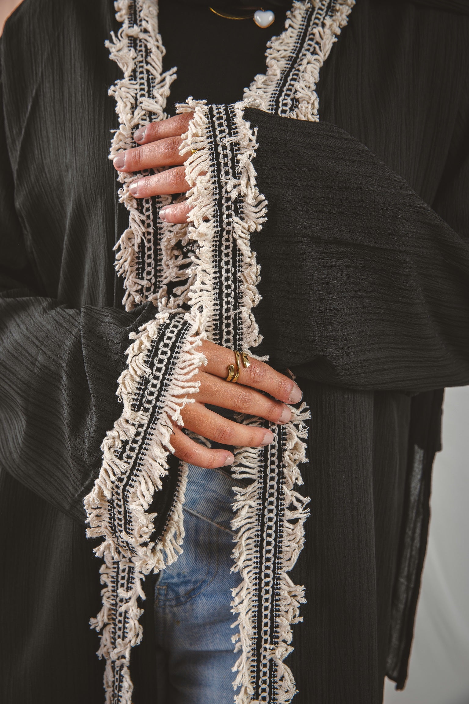 Zahra Kaftan black 5, crafted from Fresca fabric, features a unique design along the edges and sleeves, blending elegance with modern charm