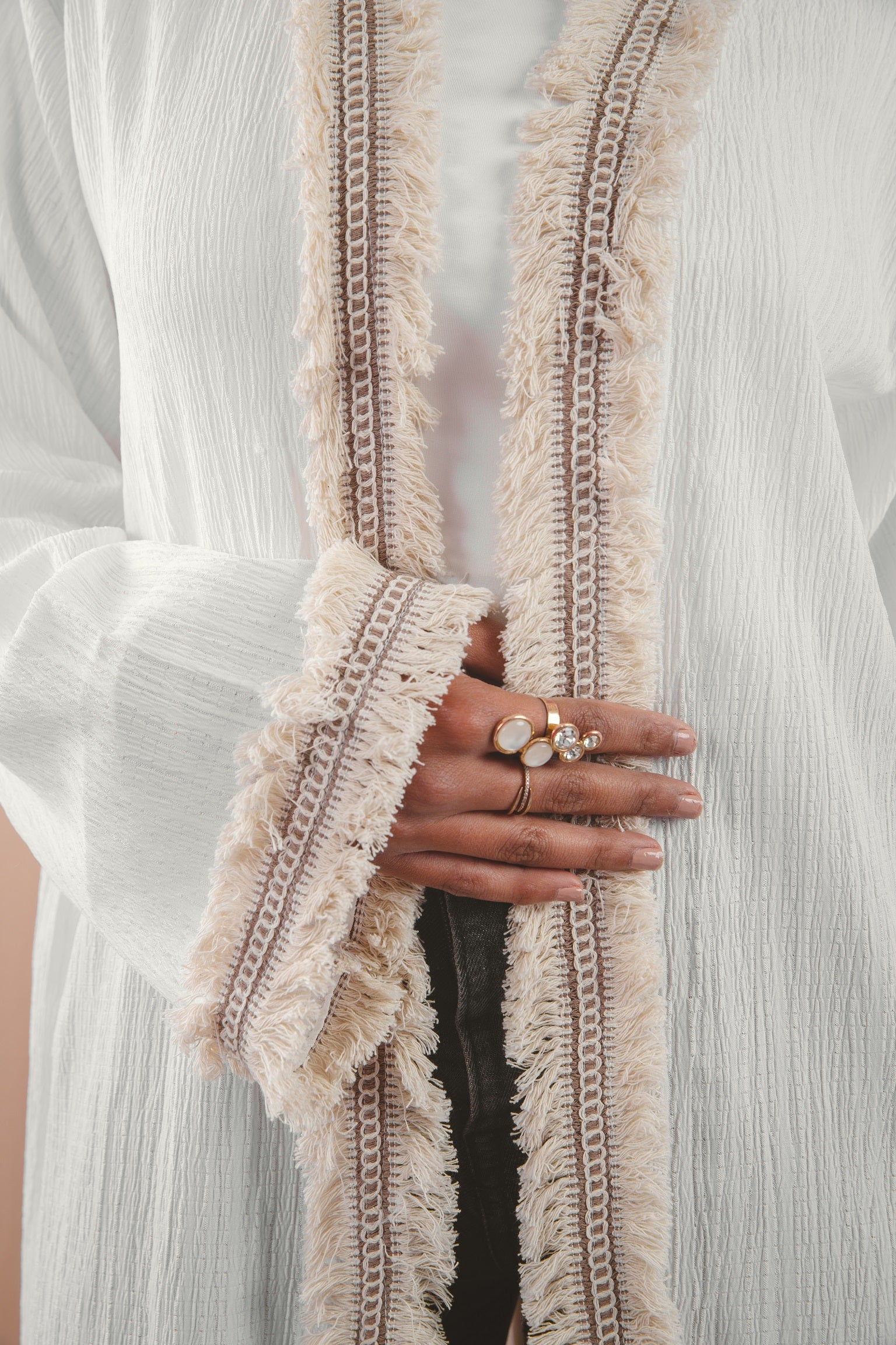 Zahra Kaftan white 4 crafted from Fresca fabric, features a unique design along the edges and sleeves, blending elegance with modern charm