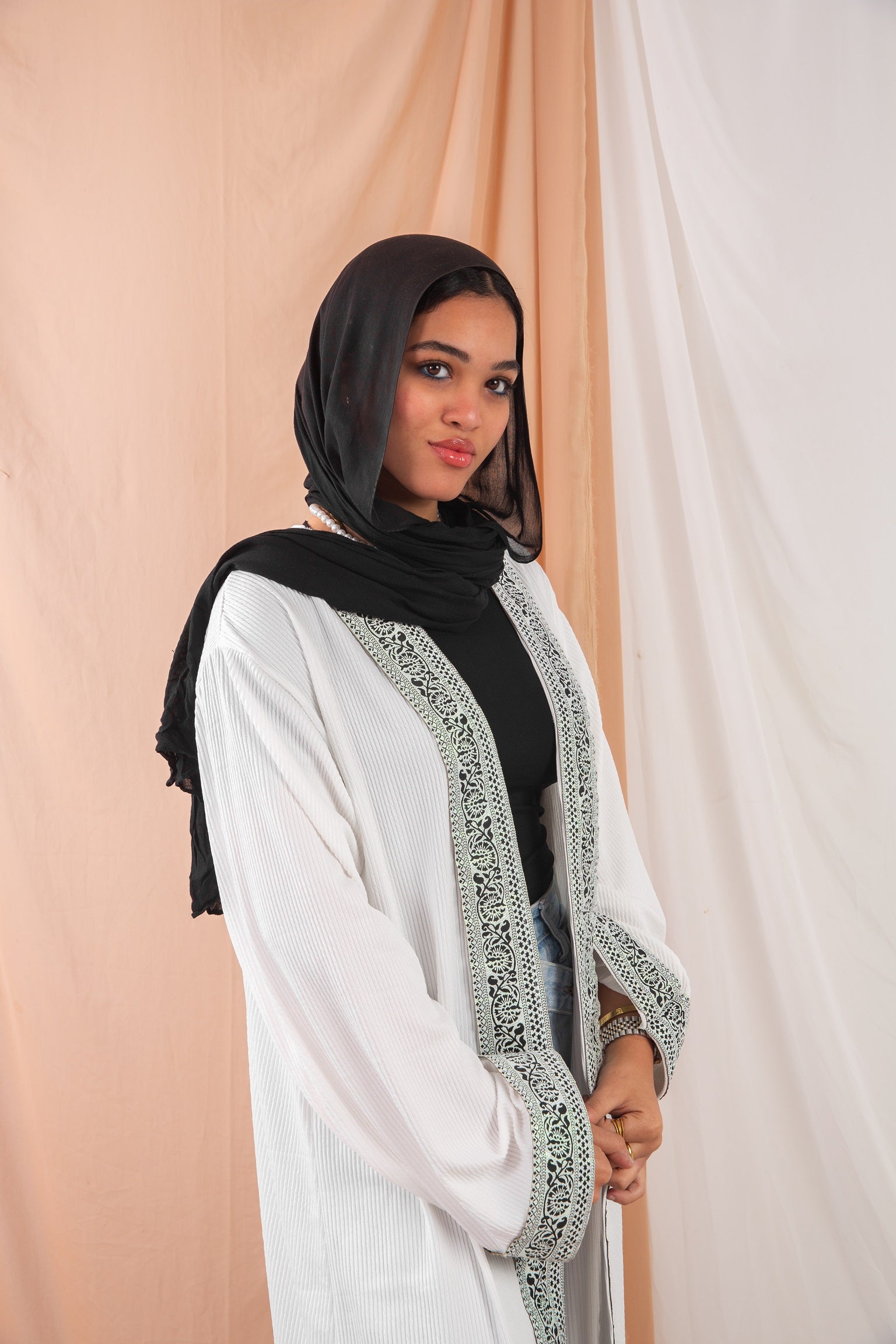 Zekra_Kaftan_White 2 crafted from crinkle rib-knitted fabric, offers a blend of texture and elegance for a timeless look