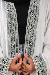 Zekra_Kaftan_White 4 crafted from crinkle rib-knitted fabric, offers a blend of texture and elegance for a timeless look